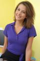 A woman in a purple shirt and black skirt posing for a picture.