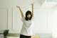 A woman standing in a room with her arms outstretched.