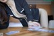 A woman in a business suit sitting at a table.