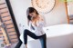 A woman sitting on a bathtub in a bathroom.